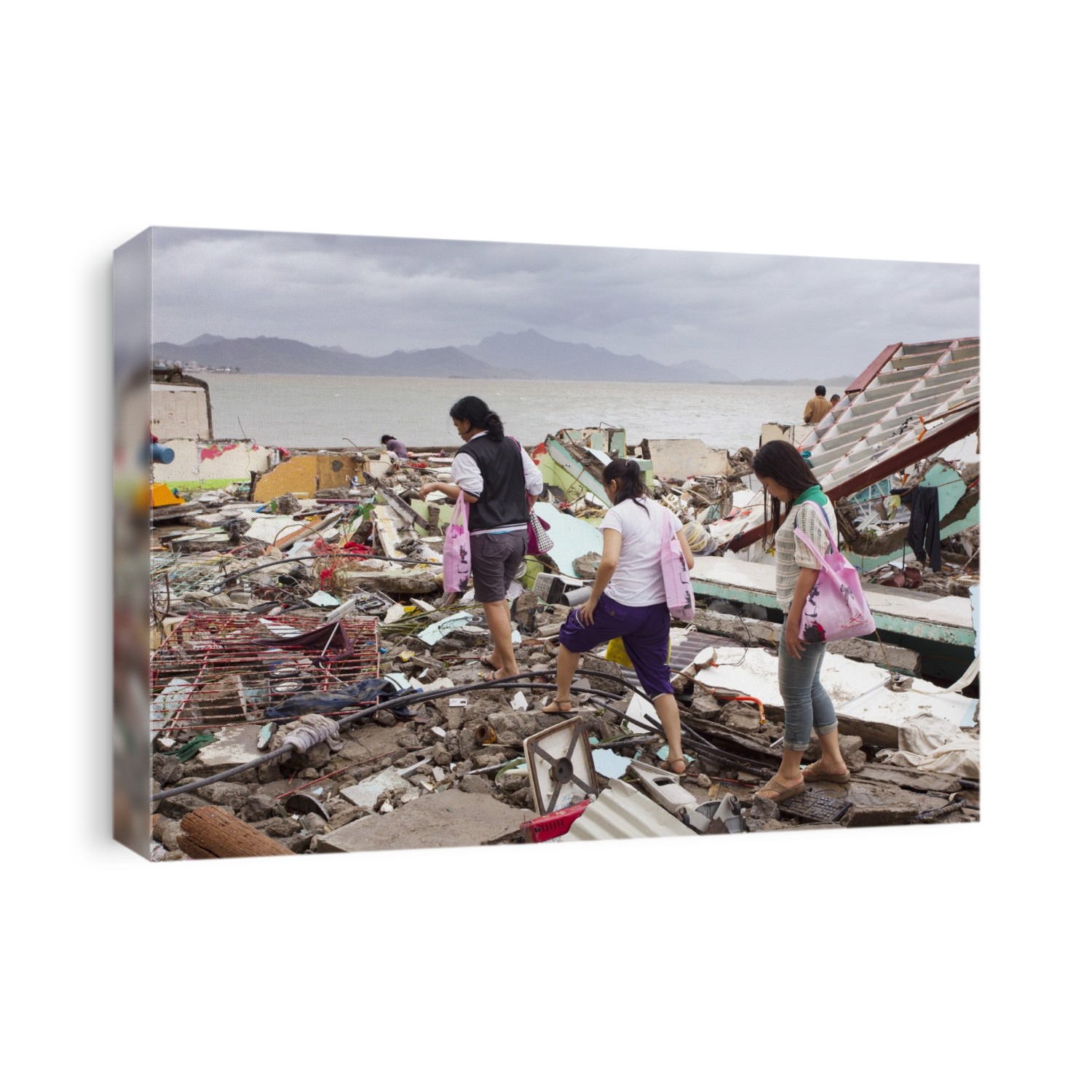 Women returning to their destroyed homes after super typhoon Haiyan. Haiyan was the strongest tropical cyclone ever recorded to have made landfall, with sustained winds of more than 300 kilometres per hour at its peak. The island of Leyte, and in particular its capital Tacloban, bore the brunt of Haiyan's force. More than 6200 people were confirmed killed, with nearly 2000 missing. Photographed in Tacloban, Leyte, in the Philippines, in November 2013.