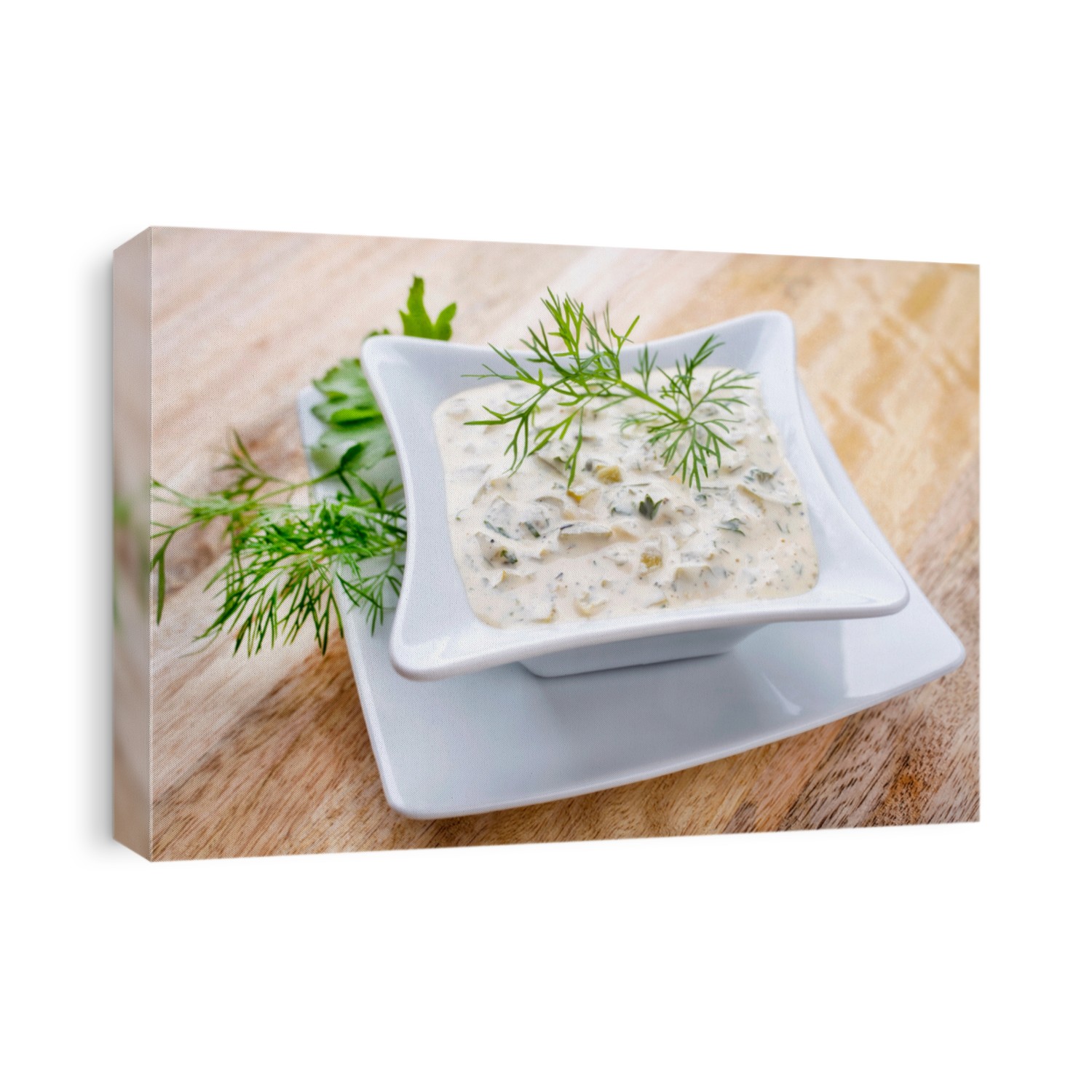 Traditional German remoulade with gherkin and dill offered in a bowl on a wooden board 